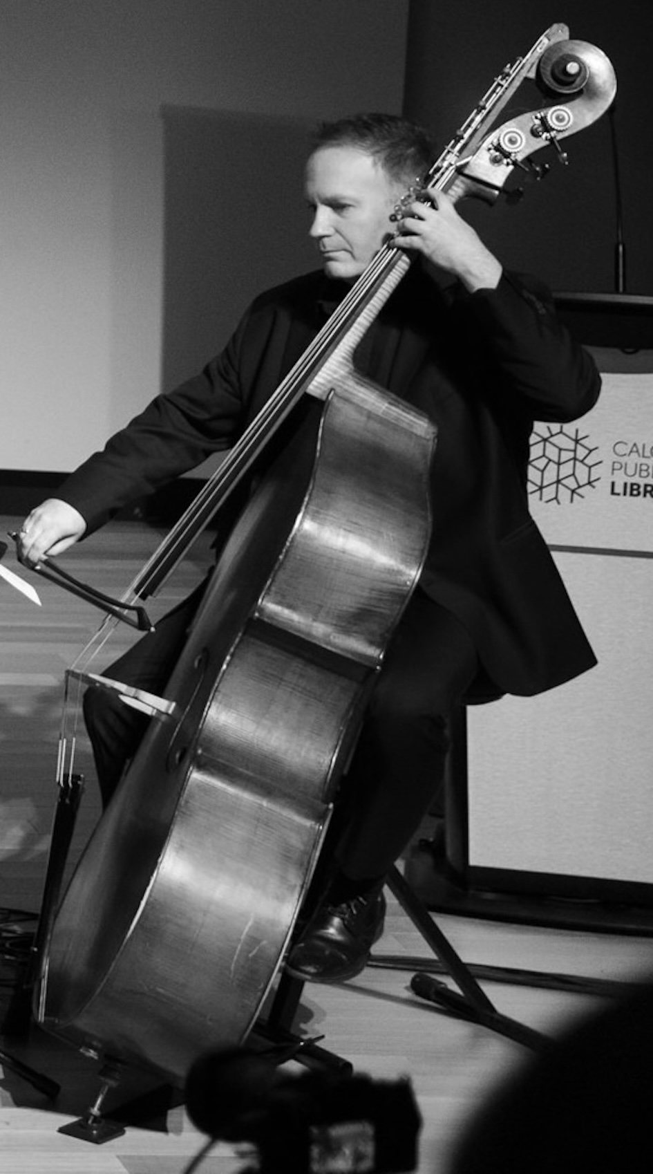 Rob Hutchinson bowing the double bass on stage